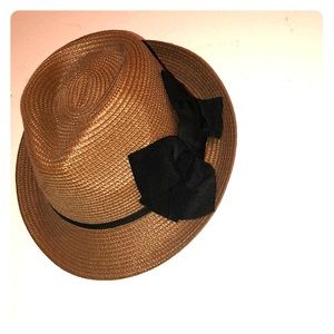 A Hat with a signature black bow.